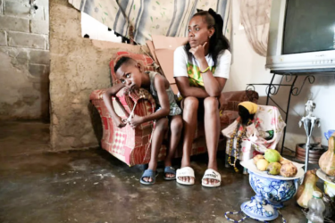 Diana Ruiz sits next to her son at their home in Havana on March 27, 2024. Shortages of food and medications, as well as long blackouts, have affected most of Cuba’s population in recent years.